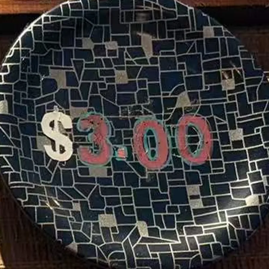 The blue plate — navy mosaic with $3.00 painted across it