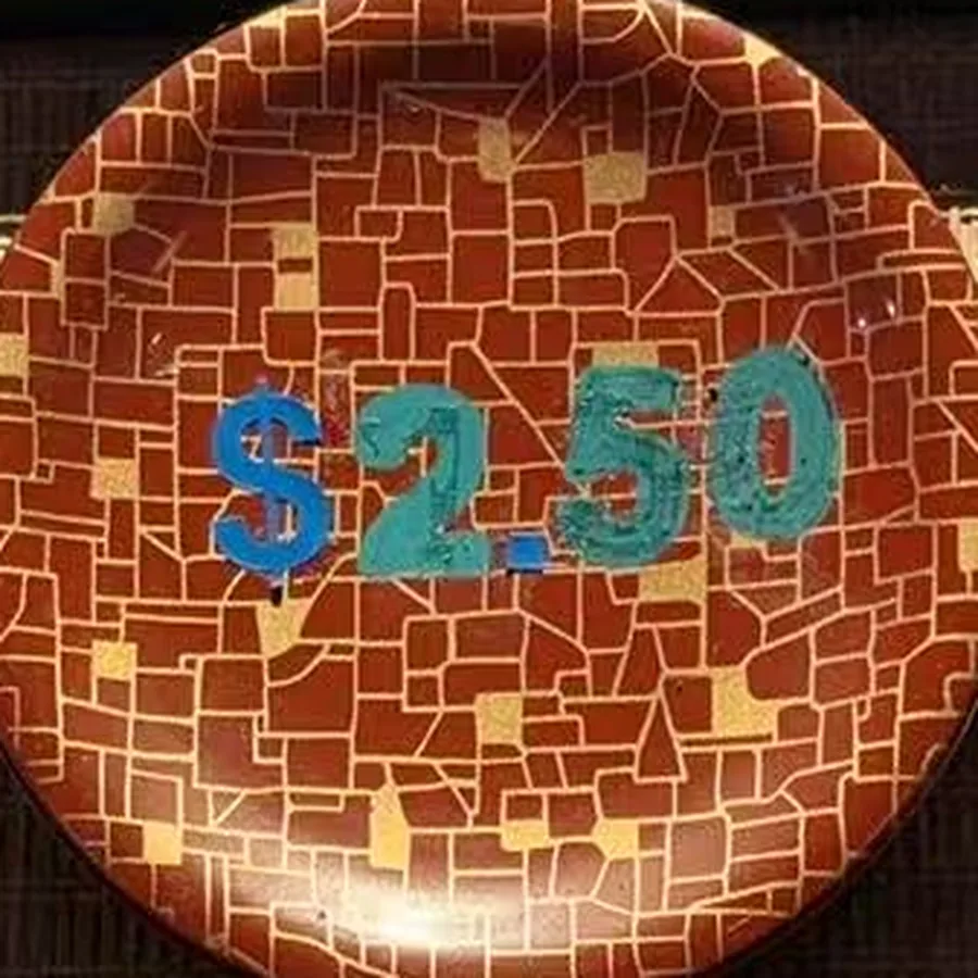 The red plate — rust mosaic with $2.50 painted across it