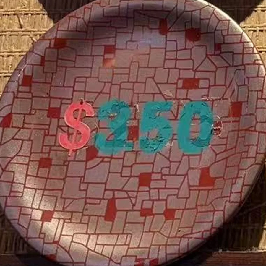 The silver plate — pale mosaic flecked with red, $3.50 painted across it