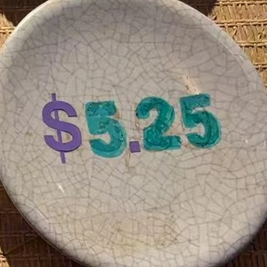 The stone plate — crackled off-white glaze with $5.25 painted across it